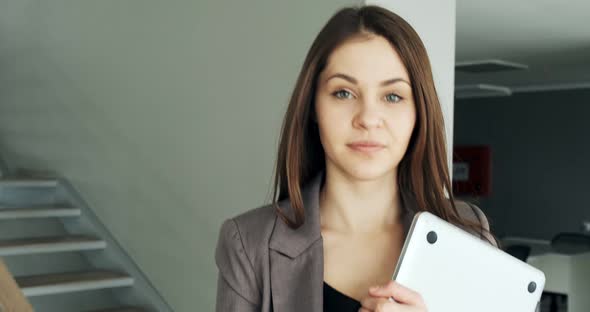 Young Business Woman Walking in Office Hall Corridor. Serious Attractive Female Goes To Conference