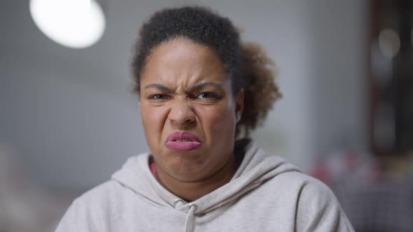 Closeup Portrait of African American Woman with Disgust Facial Expression Closing Face with Hands