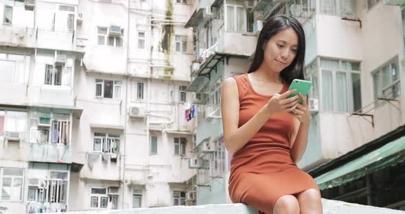 Woman use of mobile phone at outdoor 