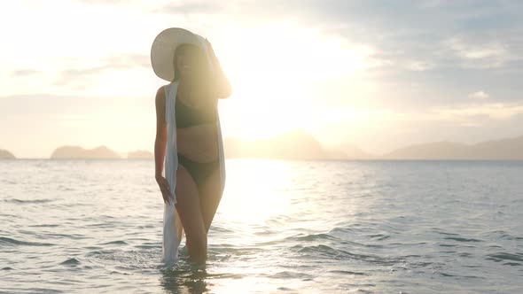 Young Woman In Bikini And Sun Hat In Sea