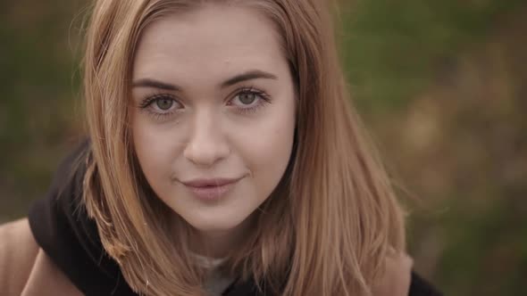 Portrait From Above of Pretty Caucasian Female Looking on Camera with Broad Smile Spending Free Time