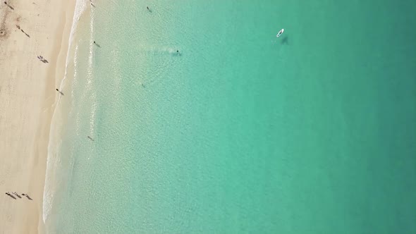 Tourists On The Seaside In Summer - Beautiful Beach In Newquay, UK With Clear Blue Water - aerial to