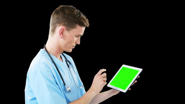 Male surgeon using digital tablet