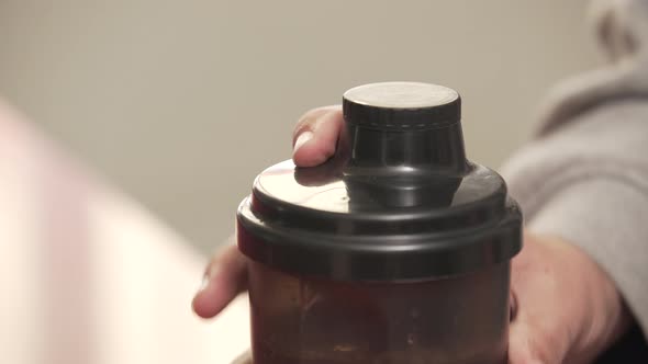 Shaking Protein Powder Into The Shaker bottle