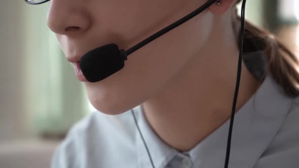 A Girl in Headphones with a Headset Conducts Consultations