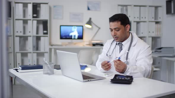 Male Physician Working Online