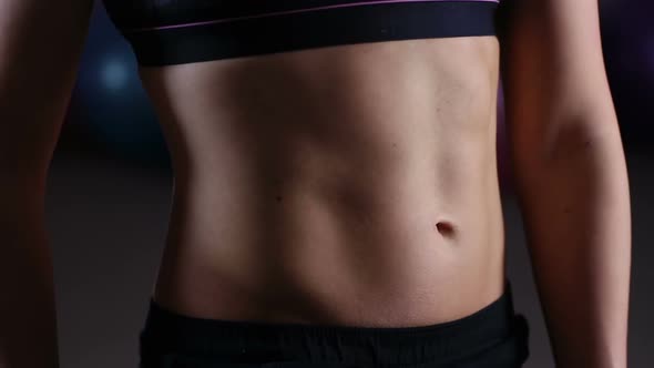 Ideal Flat Belly of Female Athlete Doing Breathing Exercises for Body Wellness