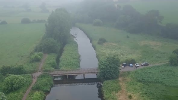 River Otter view from the sky over seen people walking on the path after having parked on the side,