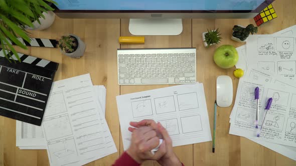 Producer Drawing Storyboards Template And Working On Computer