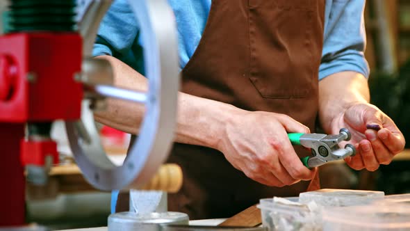 Male hands cutting a piece of stone