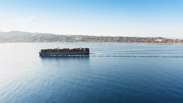 Container Ship Sails in the Calm Mediterranean Sea to the Left