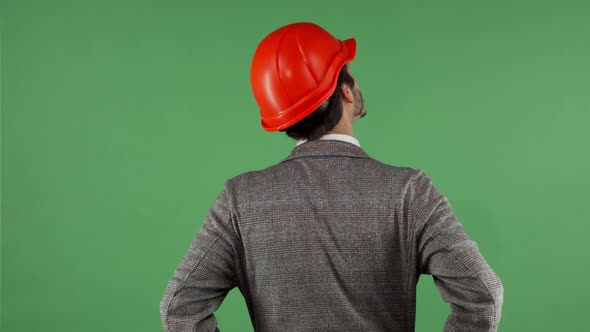 Rear View Shot of a Contactor Wearing Hardhat Looking Around on Chromakey