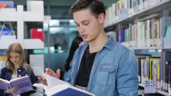 Library, Smiling Male Student Reading Book Near Shelves