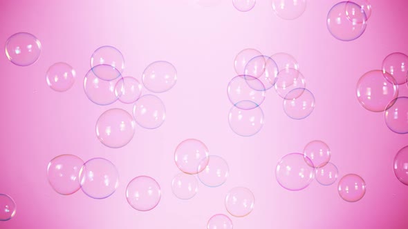 Super Slow Motion Shot of Flying Colorful Soap Bubbles on Pink Background at 1000 Fps