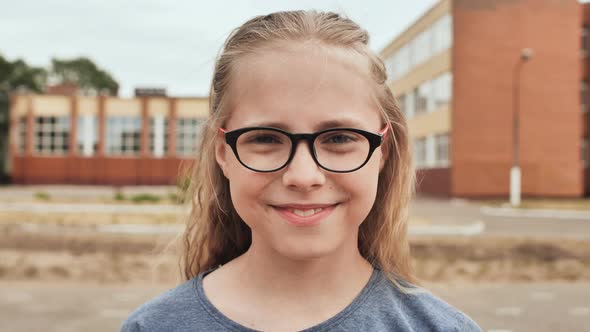 Smiling Blonde 11 Year Old Girl with Glasses