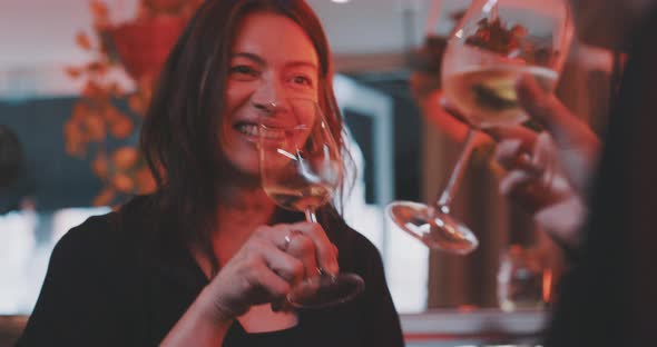 Women cheering with wine glasses