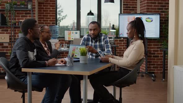 African American Team of Workers Doing Teamwork on Financial Project