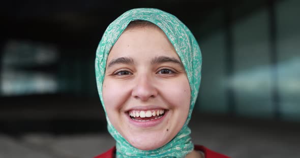 Young muslim girl smiling on camera outdoor