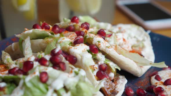 Close Up of Healthy Vegan Pitas Stuffed with Vegetables and Decorated with Pomegranate Seeds