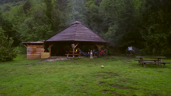 Aerial view of a wooden open hut with people enjoying the evening.