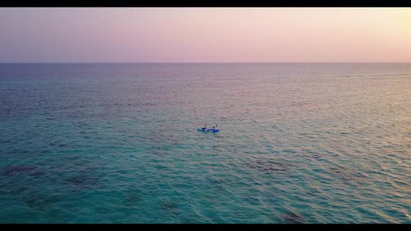 Aerial view sky of tranquil coastline beach trip by blue ocean with white sandy background of a dayo