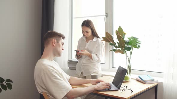 Married Couple Uses Computer Gadgets for Business Development.