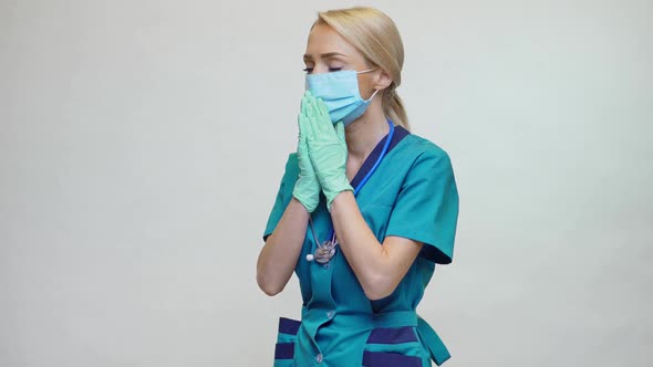 Medical Doctor Nurse Woman Wearing Protective Mask and Latex Gloves - Praying Nad Hoping Gesture