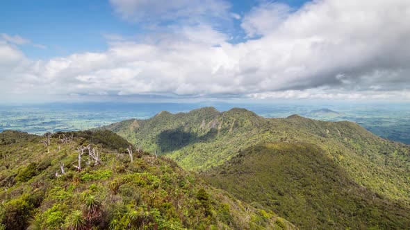 White Clouds over Sunny Forest Mountains in New Zealand Wild Nature