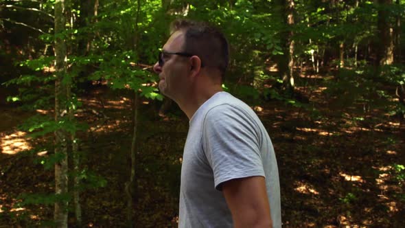 Man Walking Through Forested Landscape Near Sfânta Ana Lake In Romania - tracking shot