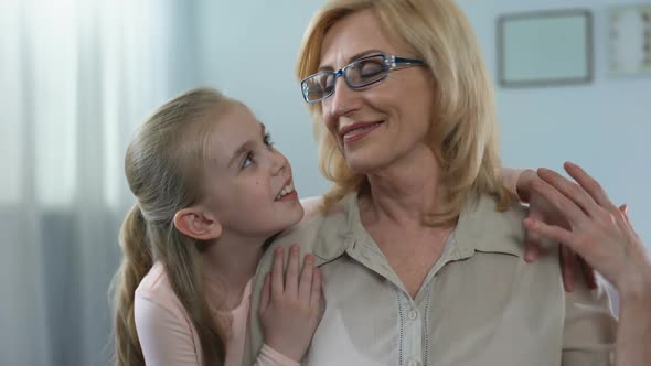 Beautiful Blond Granddaughter Hugging Her Grandmother With Love, Care, Support