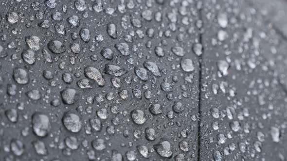 Tilt over protective water-proof fabric texture on rainy day 4K 2160p 30fps UHD footage - Tiny drops