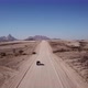 Car Driving on Gravel Road in Aerial Desert - VideoHive Item for Sale
