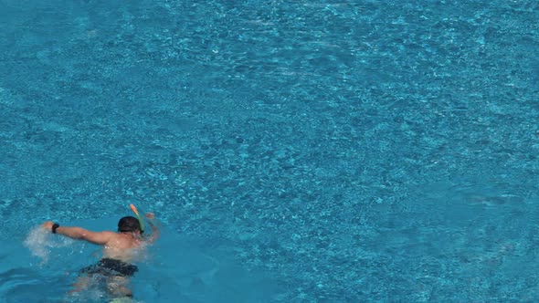 Man Swim in the Pool at the Hotel