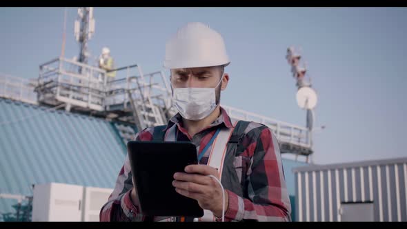 Engineer Using Tablet on a Cellular Tower