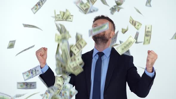 Slow Motion of Formally Dressed Man is Delighted with the Fact That a Lot of Dollar Bills are Fall