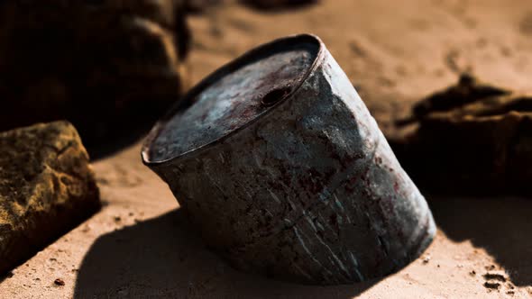 Rusty Metal Oil Barrel on Sand Beach