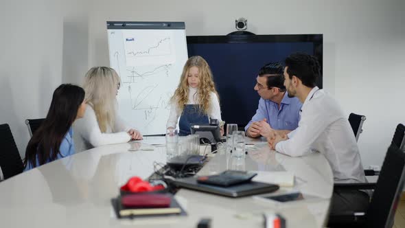 Wide Shot Portrait of Concentrated Little Charming Girl in Modern Office with Multiethnic Colleagues