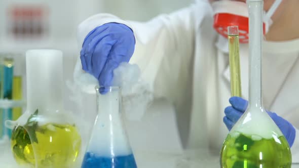 Female Lab Worker Conducting Researches Mixing Different Reagents, Chemistry
