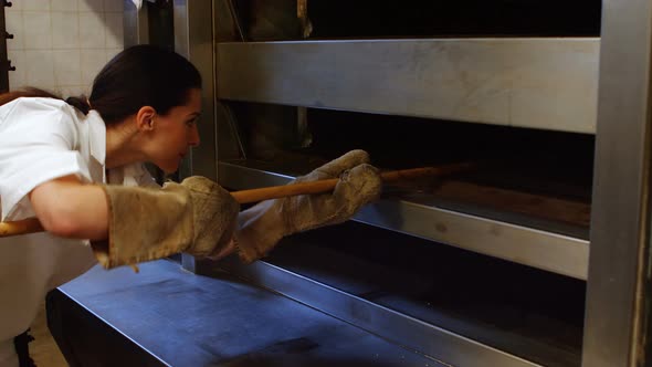 Female baker baking fresh bread