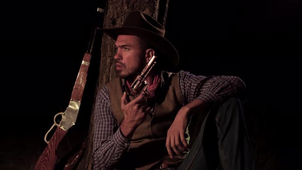 Cowboy with a Gun in the Forest at Night