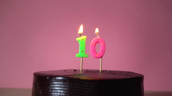 Chocolate Birthday Cake with Wick Lighting Trying to Blowout Candle