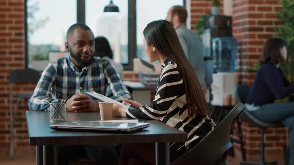 Asian Woman Interviewing Male Candidate at Recruitment Meeting