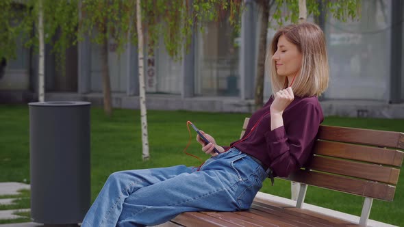 Woman Using Headphones to listen to Music,