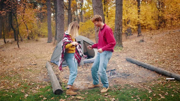 Young Couple Laughing and Dancing Having Fun in Autumn Forest