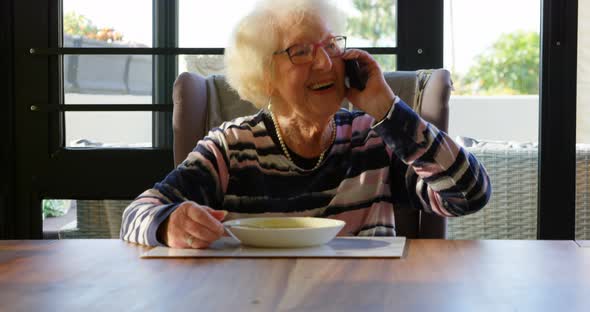 Happy senior woman talking on mobile phone 4k