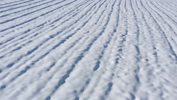 Wind made zastrugi formation in snow 4K drone footage