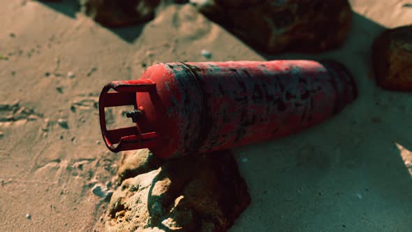 Old Rusted Gas Tank on Sand Beach