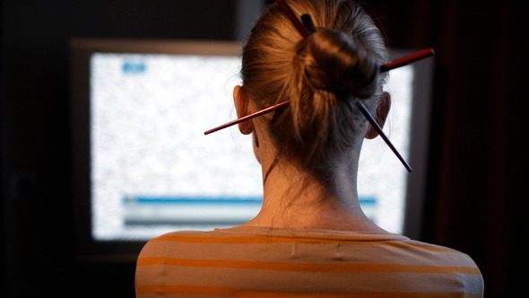 Woman Sitting In Front Of Tv Set