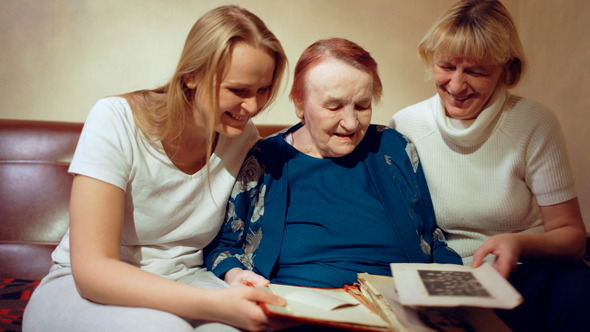 Three Women Looking Through The Family Archive