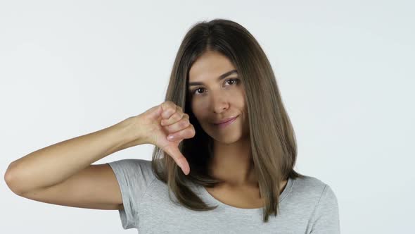 Thumbs Down by Upset Beautiful Girl, White Background in Studio